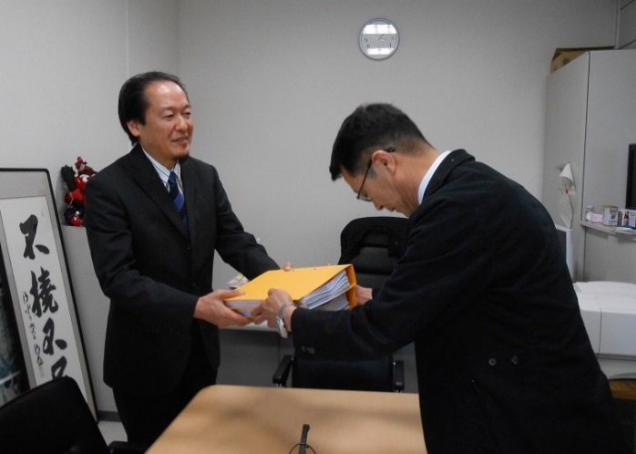 戸羽太市長に報告書を手渡している藤井幹事会議長