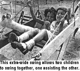 This extra-wide swing allows two children to swing together, one assisting the other.
