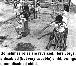 Sometimes roles are reversed. Here Jorge, a disabled (but very capable) child, swings a non-disabled child.