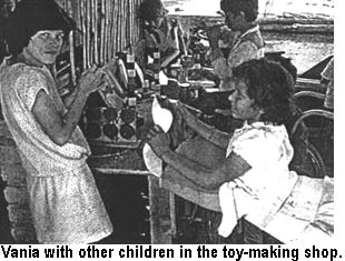 Vania with other children in the toy-making shop.