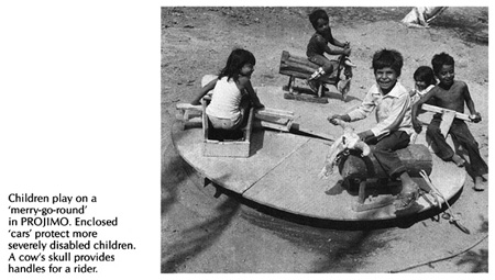 Children play on a 'merry-goround' in PROJIMO.Enclosed 'cars' protect more severely disabled children. A cow's skull provides handles for a rider.