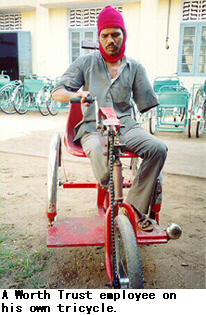 A Worth Trust employee on his own tricycle.