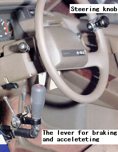 Hand-control Driving System: a steering knob and the lever for braking and accelerating.