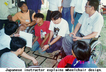 Japanese instructor explains wheelchair design.