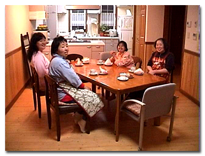photo of the several residents sitting around a dining table