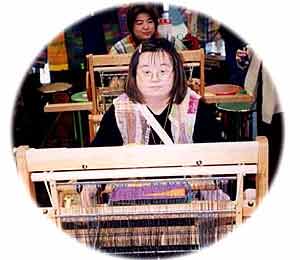 SAORI employee sitting at a loom, weaving