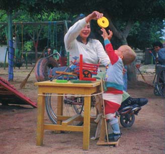 A disabled child with his standing frame(Photo)
