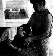 Tinin slumped forward when he sat on a table.
