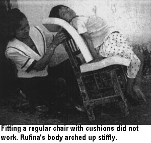 Fitting a regular chair with cushions did not work. Rufina's body arched up stiffly.