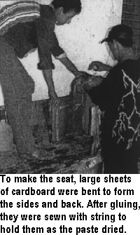 To make the seat, large sheets of cardboard were bent to form the sides and back. After gluing, they were sewn with string to hold them as the paste dried.