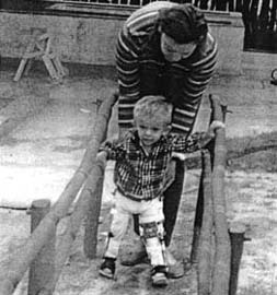 Raul tried walking between parallel bars with his new braces.