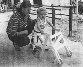 Raul experimented his new braces with a wooden walker.