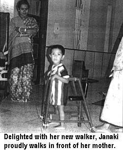 Delighted with her new walker, Janaki proudly walks in front of her mother. 