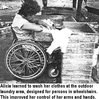 Alicia learned to wash her clothes at the outdoor laundry area, designed for persons in wheelchairs. This improved her control of her arms and hands.