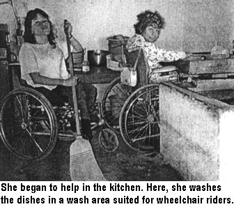 She began to help in the kitchen. Here, she washes the dishes in a wash area suited for wheelchair riders.