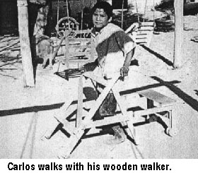Carlos walks with his wooden walker.