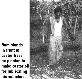 Ram stands in front of castor trees he planted to make castor oil for lubricating his catheters.