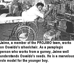 Jaime, a member of the PROJIMO team, works on Osvaldo's wheelchair. As a paraplegic person who works from a gurney, Jaime well understands Osvaldo's needs. He is a marvelous role model for the younger boy.