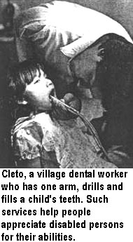 Cleto, a village dental worker who has one arm, drills and fills a child's teeth. Such services help people appreciate disabled persons for their abilities.
