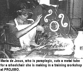 Maria de Jesus, who is paraplegic, cuts a metal tube for a wheelchair she is making in a training workshop at PROJIMO.