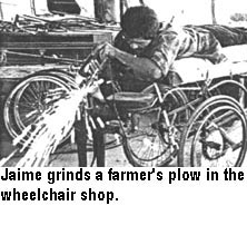 Jaime grinds a farmer's plow in the wheelchair shop.