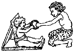 A school girl uses a rattle to play with a multiply-disabled child.