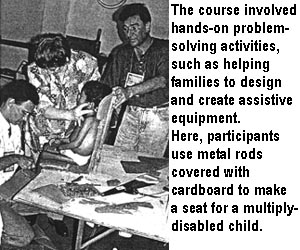 The course involved hands-on problem-solving activities, such as helping families to design and create assistive equipment. Here, participants use metal rods covered with cardboard to make a seat for a multiply-disabled child.