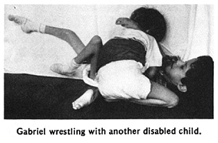 Gabriel wrestling with another disabled child.