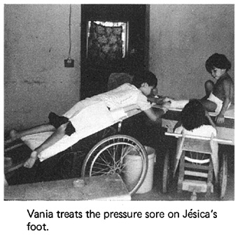 Vania treats the pressure sore on Jesica's foot.