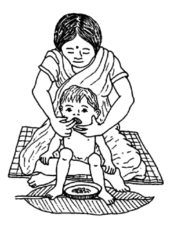 A mother hold a child in a good position on her lap, using her legs and body to give support.