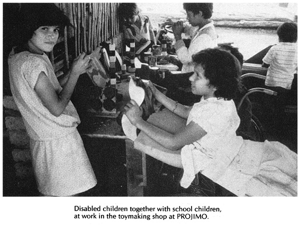 Disabled children together with school children, at work in the toymaking shop at PROJIMO