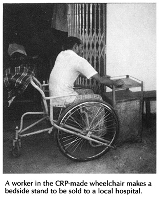 A worker in the CRP-made wheelchair makes a bedside stand to be solid to a local hospital.