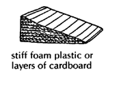 Stiff foam plastic or layers of cardboard. 