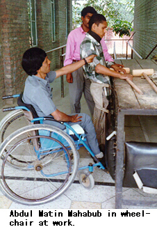 Abdul Matin Mahabub in wheelchair at work.