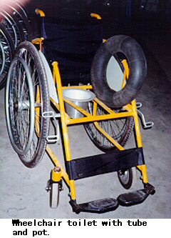 Wheelchair toilet with tube and pot.