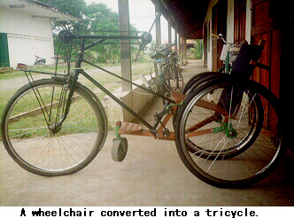A wheelchair converted into a tricycle.