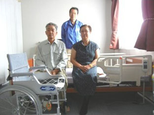 Mr.and Mrs. Soto, and Mr. Isobe, General Secretary beside the care bed offered