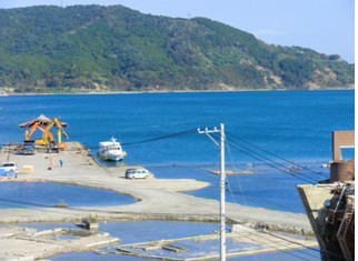Flooded roads along the coast whenever high tide comes, viewed from the Community Medical Center of Onagawa Town 