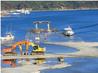 Flooded roads along the coast whenever high tide comes, viewed from the Community Medical Center of Onagawa Town 