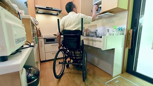 Photo of a person in a wheelchair in a kitchen