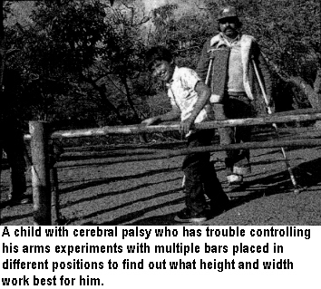 A child with cerebral palsy who has trouble controlling his arms experiments with multiple bars placed in different positions to find out what height and width work best for him.