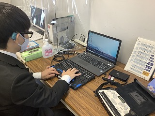 Man looking at a laptop on the desk